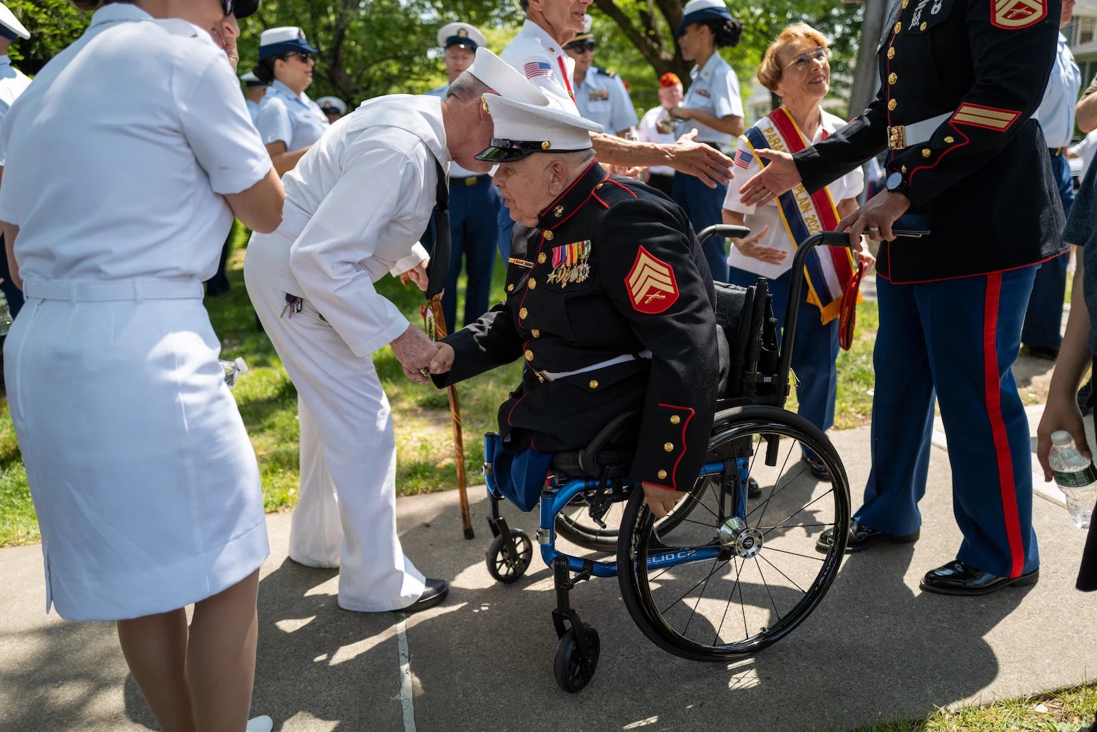 Parade grand marshal, U.S. Marines Sgt. Michael Sulsona, greets a Navy veteran